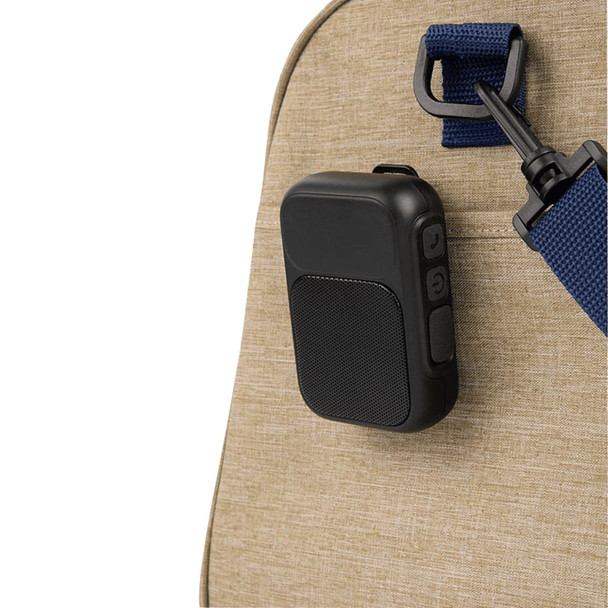 A black magnetic Bluetooth speaker attached to a tan bag strap. The speaker features buttons and a sleek design.