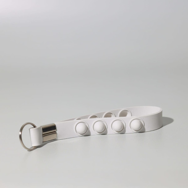 A white Popper Stress Reliever Key Chain featuring multiple push buttons and a metal keyring.