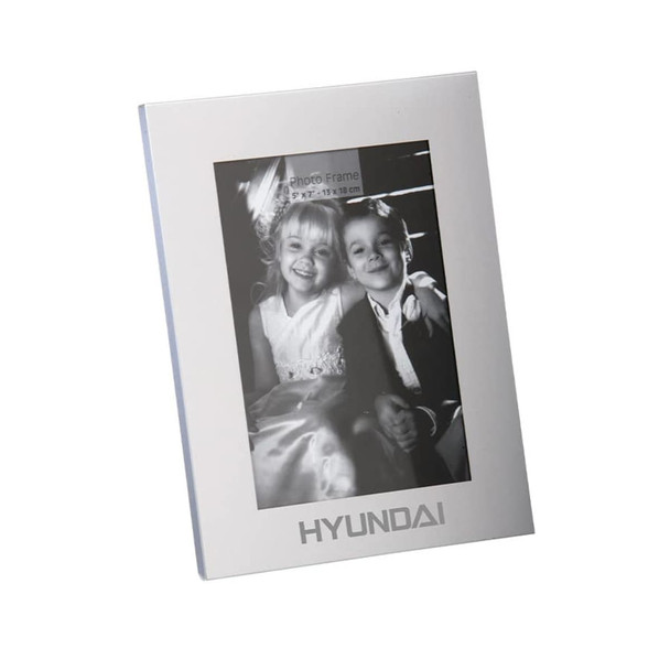 A classic aluminium photo frame in silver, featuring a black and white photo of two children. Includes a logo.