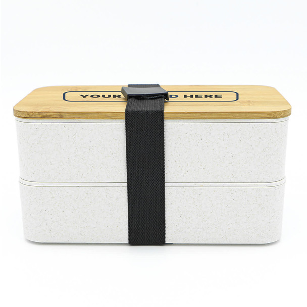 A two-layer lunch box in white with a bamboo lid and a black strap, featuring a logo on the front.