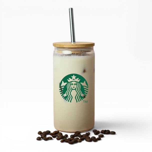 A drink bottle with a bamboo lid and metal straw, featuring a logo and filled with a creamy beverage, placed on coffee beans.