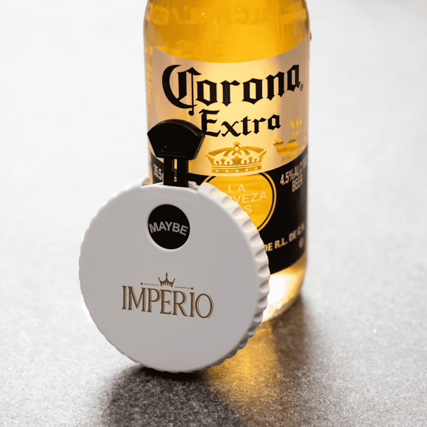 A drink bottle featuring a white bottle opener spinner, displaying the colours gold and black. It has a logo.