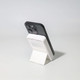 A black and white Turbo 5000mAh wireless charging power bank set on a stand, showcasing its sleek design.