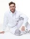 A white fleecy hoodie with a front pocket, featuring a logo, worn with matching light grey pants.