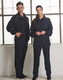 A navy track jacket with yellow accents displayed on models. The jacket features pockets and a collar.