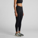 Active seamless leggings in black, featured on a model, paired with athletic shoes. The product includes a logo.