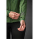 A green women's jacket featuring a zippered pocket on the sleeve and a fitted design. It has a logo on the fabric.