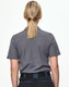 A grey short-sleeved polo shirt viewed from the back, featuring a simple design and a logo on the collar.