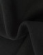 A close-up of soft, black fabric showcasing a textured surface, indicating a fleece material.