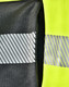 A bright yellow work jumper featuring reflective stripes and a zipper pocket in a contrasting dark grey fabric.