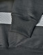 A close-up of a dark green jumper featuring a grey striped pattern and ribbed cuffs, with a branding logo.