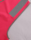 A bright pink safety vest featuring reflective shoulder tapes and contrasting grey edging. It includes a logo.