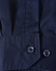 A close-up of a blue long-sleeve shirt featuring segmented tape, with a buttoned cuff detail.