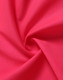 A swirl of bright pink fabric, showcasing a textured surface ideal for safety apparel.