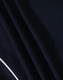 Close-up of a navy blue polo shirt fabric with a textured pattern and white detailing. The shirt features a logo.
