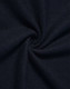 A close-up of dark navy fabric, showcasing a textured, woven pattern.