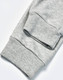 A pair of grey poly/cotton terry sweat pants with ribbed cuffs. The image highlights the fabric texture.