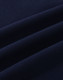 A close-up of navy cotton fabric with visible stretch and texture, ideal for polo shirts.