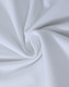 A close-up view of soft, white cotton fabric, showcasing a smooth and stretchy texture.