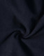 A close-up view of dark navy softshell fabric, featuring a smooth texture with a slight sheen.