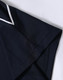 A dark navy blue polo shirt with a white trim at the collar and sleeve, featuring a logo.