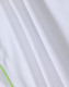 A white polo shirt with a green trim, featuring a textured fabric and a logo.