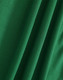 A close-up of soft, textured green fabric, showcasing folds and depth suitable for polo shirts.