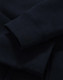 A close-up of a navy full-zip fleecy hoodie showcasing the cuffs and fabric texture. It has a logo.