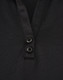 A black polo shirt featuring a textured fabric and two buttons at the neckline. It has a logo on it.