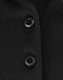 A close-up of a black polo shirt featuring buttons and a subtle texture, highlighting its sustainable fabric.