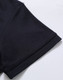 A close-up of the sleeve of a black Ladies' Truedry Pique Polo shirt, featuring a simple design and a brand logo.