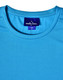 A light blue performance T-shirt with a crew neck and a logo on the label. The fabric appears breathable and smooth.