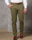Men's Boston Chino Pants in olive green, featuring a slim fit and pockets, paired with a brown belt and shoes.