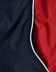 A close-up of a unisex jacket featuring a black exterior and a red lining with contrasting white piping.