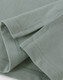 A close-up view of a light green men's cotton stretch polo shirt, highlighting the fabric and stitching details.