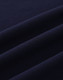 A close-up of navy cotton fabric with visible texture and stretch features, suitable for polo shirts.