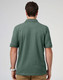 A men's cotton stretch polo in a green hue, featuring a classic polo collar and short sleeves, with a logo.