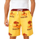 Men's yellow polyester board shorts featuring a tropical design with palm trees and a drawstring waistband. Includes a logo.