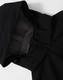 A black men's softshell full zip hoodie featuring a hood and zipped front. It has a logo on the fabric.