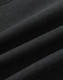 A close-up of a black softshell fabric with a smooth texture, featuring folds and creases.