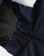 A navy men's softshell full zip hoodie with a grey lining and a zipper closure. Features a hood and logo.
