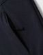 A navy softshell full zip hoodie featuring a zippered pocket on the side and a logo.