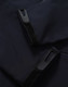 A dark navy softshell hoodie featuring zippered pockets and Velcro closures. It has a sleek and modern design.
