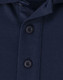 A close-up of a navy men's polo shirt featuring a button placket and collar. The fabric appears soft and sustainable.