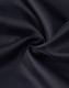 A black fabric with a smooth texture, showcasing the material of a puffer jacket.