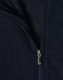 A navy softshell high-tech jacket featuring a zippered front and a fleece lining. The jacket includes a logo.