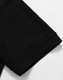 A black Men's Truedry Pique Polo shirt showcasing the sleeve detail. The shirt features a logo.