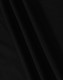 A close-up of black fabric, featuring smooth folds and a soft texture, ideal for a polo shirt.