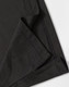 A close-up of a black polo shirt featuring a neatly stitched hem and collar. The fabric texture is visible.