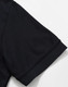 A black polo shirt with a solid design, featuring short sleeves and a classic collar. Includes a logo.